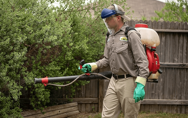 image of an exterminator outside